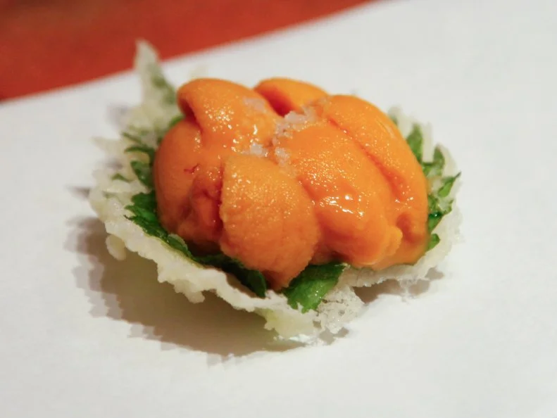 There are many excellent tempura spots in Tokyo, but nine-seat Motoyoshi stands out both for the superior quality of its ingredients and the restaurant’s soothing interior, which blends traditional and contemporary Japanese aesthetics. Though sheathed in a crisp coating of golden batter, the deep-fried delicacies taste impossibly light. Chef Kazuhito Motoyoshi has a winning way with vegetables: His signatures include spears of asparagus, pudding-like croquettes of sweet Japanese corn, and fried shiso leaves crowned with bright-orange uni from Hokkaido. Choose your own o-chokko (sake cup) from a tray of antique ceramic vessels to accompany the meal.