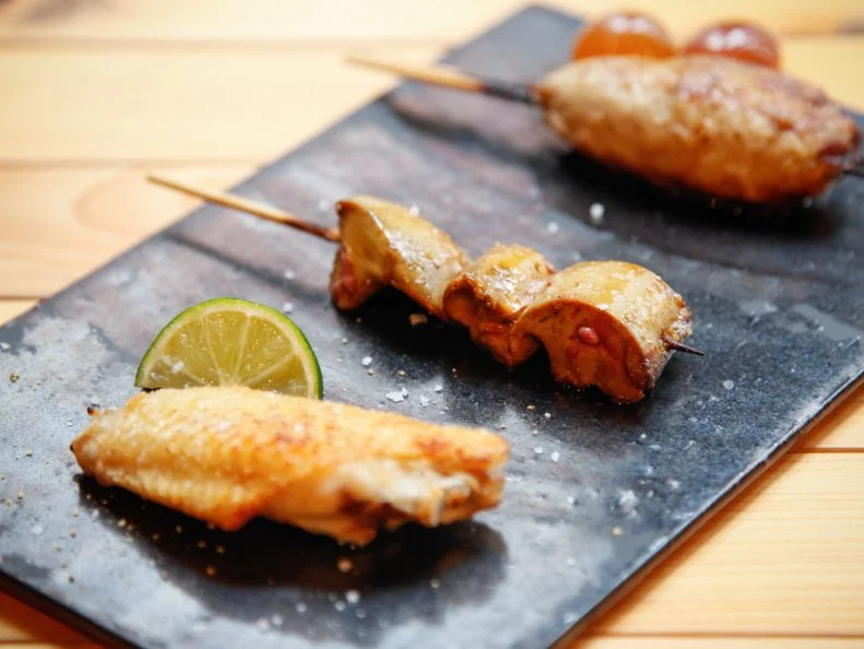 Yakitori often conjures images of inexpensive street food, but Ranjatai elevates the skewered dishes to Michelin-starred levels of refinement. Chef Hideyuki Wadahama uses premium birds from Akita and Hyogo Prefectures, and he carefully grills the chicken over binchotan charcoal embers to retain the juiciness of the meat. The ¥6,000 tasting menu comes with six grilled items, including Wadahama’s signature cumin-spiced tsukune meatball, along with a velvety chicken-liver mousse. Those who are still hungry should try the roasted pigeon, which pairs superbly with a pinot noir from the well-curated wine list.