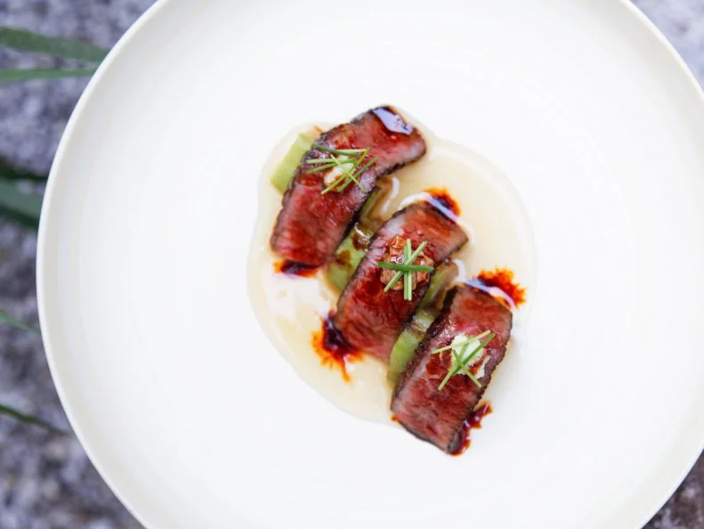 Kappo ryori is the more casual cousin of kaiseki, the multicourse Japanese haute cuisine that originated in Kyoto. At Shirosaka, Chef Hideki Ii infuses traditional fare with modern sensibilities and creative flair. His signature dish is as finely wrought as a Faberge egg: Nestled into a mound of diced tuna surrounded by fragrant ginger broth, a white rice-cracker orb conceals a layer of dashi gelee with quail egg yolk and black herring roe. All of the dishes on the ¥7,800 seasonal tasting menu are artfully presented and served at an immaculate wooden counter in the main dining room, which looks out onto a lovely miniature garden.