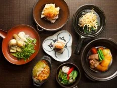 Opened two decades ago, this stylish haven in hipster-approved Nakameguro still sets the standard for contemporary Japanese design. The sleek interior by owner Shinichiro Ogata combines wood, stone and metal with washi-paper fixtures, to gorgeous effect. The menu, which changes monthly, comprises elegant takes on Japanese home-cooking classics that reflect the restaurant’s philosophy of simplicity. The vegetable palette is a colorful assortment of seasonal produce in a variety of preparations — steamed, pickled and marinated — presented in a wooden box like a gift. The five-course, ¥6,000 prix fixe set comes with a choice of starters, like duck and taro root in walnut sauce, and mains, including chargrilled wagyu. The spacious dining room on the second floor offers counter and table seating; the lounge downstairs is a chilled-out den serving sake, wine, shochu and Japanese whisky.