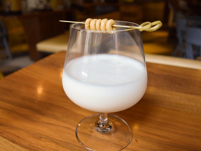 After reading about a bartender infusing genever with white bread, SoBou’s bar chef Laura Bellucci bought all of her favorite cereals and started her own carb-infusion trials; Honey Nut Cheerios in rum won out. To create Honey Buzz Milk Punch, she shakes the rum with honey syrup, El Guapo Holiday Pie Bitters and whole milk, all strained and garnished with cereal and ground cinnamon. “It's playful and silly and it tastes like fancy, doctored-up cereal milk,” she says. 