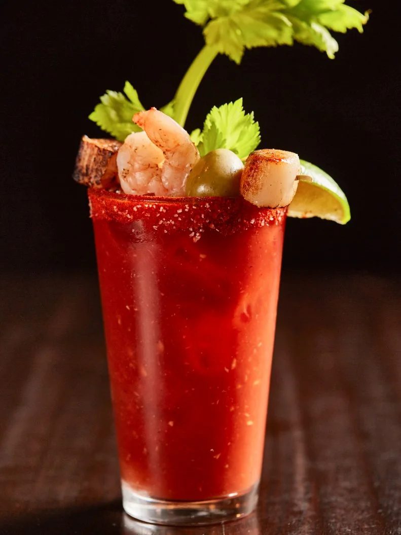 Tanta’s house Bloody Mary eschews the typical vodka for pisco, a Peruvian unaged brandy. But its real secret ingredient lies in the inclusion of homemade leche de tigre, the citrus-based marinade that cures seafood in Peruvian ceviche. Tangy, savory and umami-rich, the marinade contains lime juice, onion, chiles, salt, pepper and a little fish juice, with kick from a habanero-like pepper. The cocktail is served in a chile salt-rimmed glass with rotating garnishes including celery, grilled shrimp and seared sea scallops.
