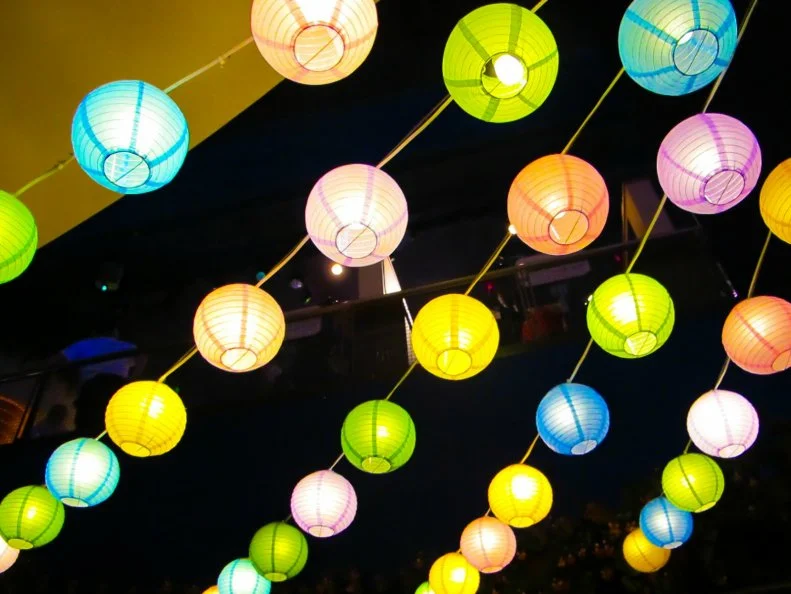 Colorful yard lanterns strung up at a party. These lanterns are also known as Chinese lanterns
