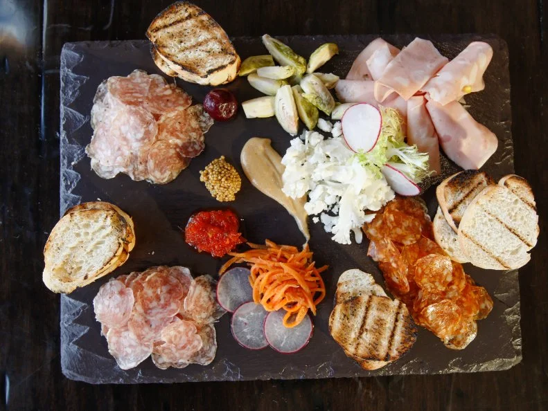 Chances are you’ve probably seen or tasted Creminelli’s meats before, regardless of where you live. Born into a family that has been curing meats in Italy since the 1600’s, Cristiano Creminelli brought his meat making skills stateside to Salt Lake City in 2006, and has been wowing taste buds ever since. The Farm at Park City Mountain Resort, which specializes in seasonal, local fare, showcases the award-winning salami on a charcuterie board, with mustard, pepper relish, house pickles and grilled bread.