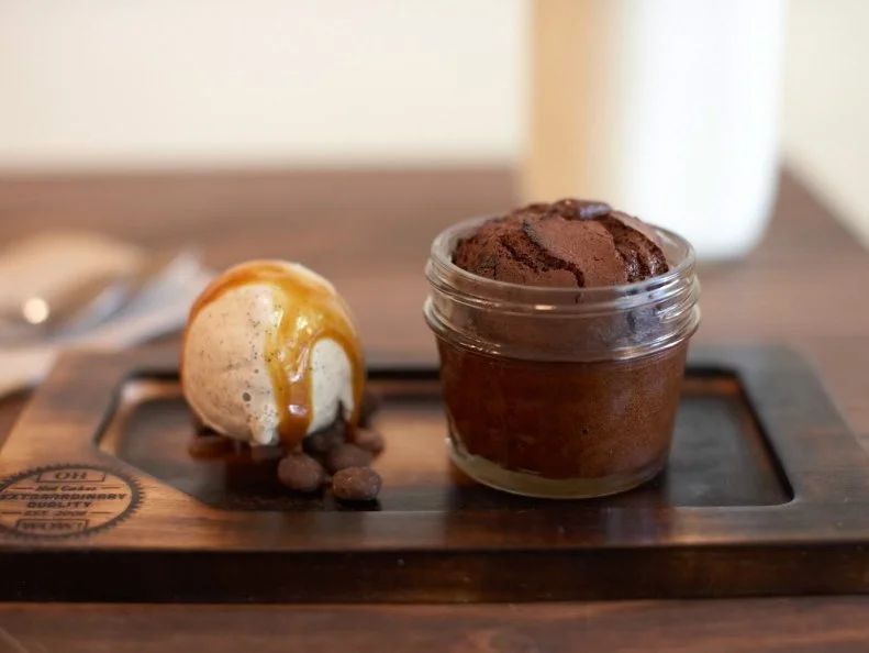 Theo Chocolate sets a new level of chocolate devotion in the Pacific Northwest. Autumn Martin left her dream job as Head Chocolatier of Theo to open Hot Cakes â   a sort of sugar shack that offers everything from boozy shakes to cookies, smoked chocolate chips, caramel sauces and her signature dessert, molten chocolate cakes. What started out as a DIY dessert business springboarded by her incredible calling-card recipe (Take-n-Bake Molten Chocolate Cake), is now a full-fledged store with multiple locations and a thriving retail business.