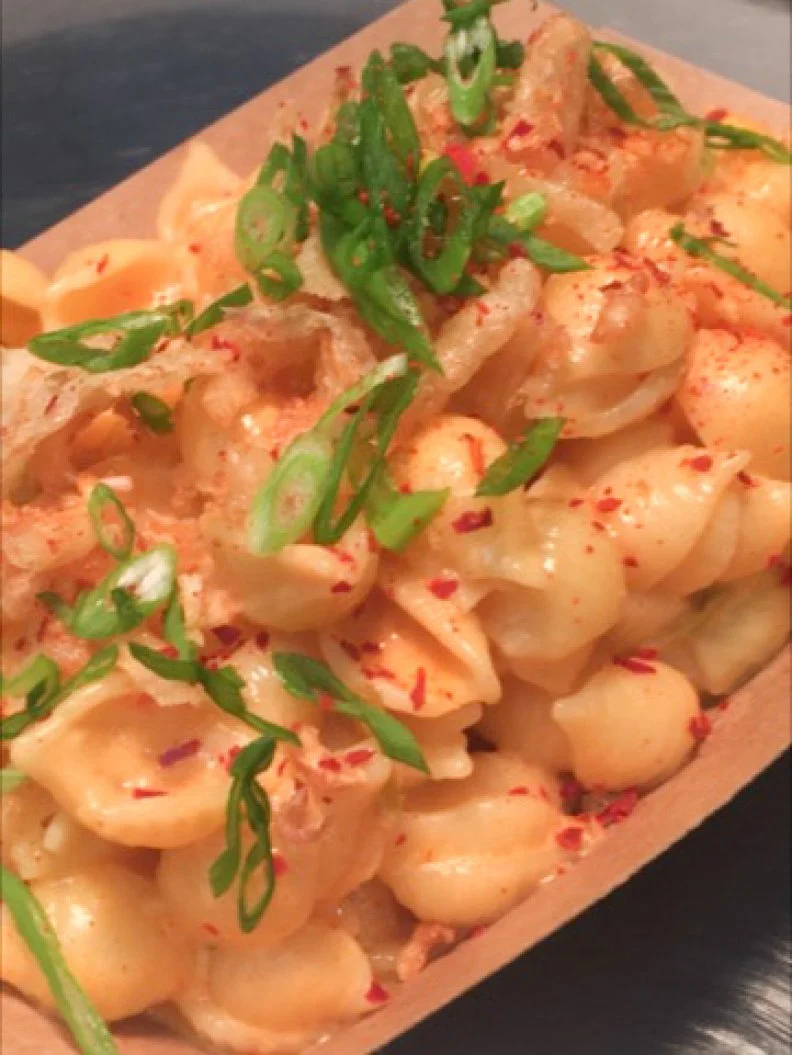 Comfort food gets a Korean twist at this White Center quick-serve joint. Here, Executive Chef Brian O’Connor serves sustainably raised Korean fried chicken and biscuits along with a slew of full-flavored riffs on American classics; that includes an excellent Kimchi Mac n’ Cheese. Shell pasta is tossed with a Cheddar cheese sauce until coated, then combined with chopped kimchi made by a local Korean woman who owns a shop across the street from the restaurant. But wait, there’s more! It’s elevated, yet again, with additional contrasting elements on top, including fresh-cut green onions, crispy garlic, crispy shallots and a kick of spice in the form of Korean chile powder.