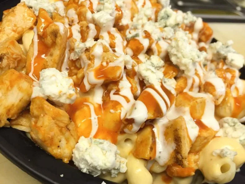 Rhode Island cheese lovers are a lucky bunch. This Providence storefront specializes in "Mac, Melts, More." While most chains offer healthy rice or salad in their bowls, Say Cheese lets guests choose toppings for a mac and cheese base. Twisted tubes of al dente pasta are slathered in the shop’s signature cheese sauce, made with grated smoked Gouda, Cheddar and heavy cream. Say Cheese classics include The Jersey (Taylor ham pork roll, banana peppers, olives, onions and Cheddar) and Wildcat (pulled barbecue pork, Fox Point pickles and Cheddar). Those who like spice — and wings! — should go for the Buffalo Chicken mac bowl, featuring grilled and sauteed chicken tossed in Buffalo sauce, placed on top of the mac, sprinkled with blue cheese crumbles and drizzled with extra sauce.