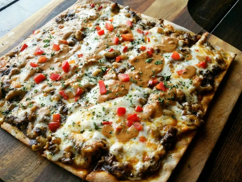 Once upon a time, pizza was purely Italian with few toppings outside the usual repertoire of pepperoni, meatballs, eggplant and onion. Nowadays, crusts are slathered with all kinds of melting pot ingredients. This Dallas pizzeria specializes in American-style scratch-made pies covered with creative flavors like bratwurst, tomatillo sauce and house-braised chicken tikka masala. Mac and cheese lovers adore the Chili Mac, consisting of housemade Texas red chili and four-cheese mac and cheese baked on Stonedeck’s signature thin crust. The pie is finished with another layer of cheesy satisfaction, Dave’s Pub Queso, and red bell pepper.