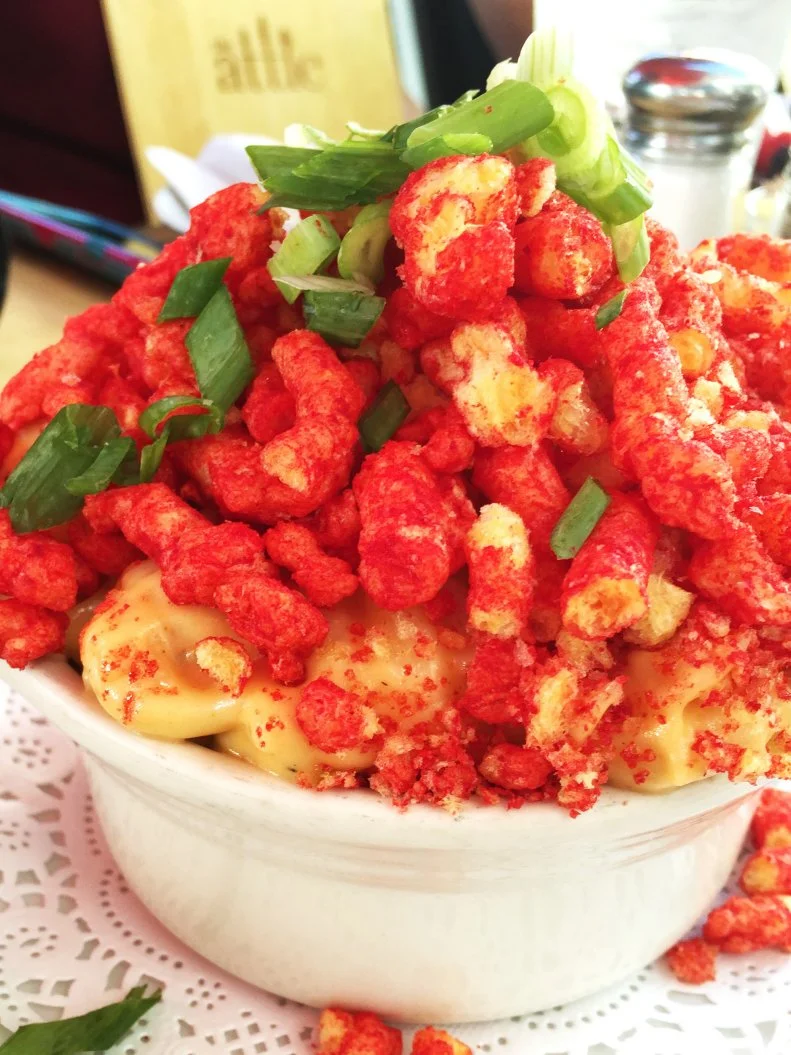 This East Broadway spot is known for its envelope-pushing riffs on classic Southern fare. Its playful flavor combinations and visually stunning presentation have made it an Instagram darling with nearly 10,000 followers. The most-liked dish: Mac n' Cheetos. Tubular pasta is coated in a traditional Cheddar, mozzarella and Jack cheese sauce, then finished with an unconventional topping: crumbled Flamin’ Hot Cheetos and green onions. This dish is so popular that The Attic has dedicated a section of its menu to six different mac and cheese options, including the Reggae, the original cheesy dish, and the mouth-searing Jalo Bac, made with sliced jalapenos as well as chopped, candied cayenne bacon. It’s like a high school dream imagined in real life.