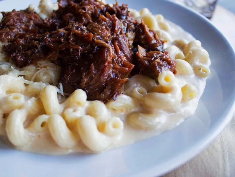 Possibly the most-famous restaurant mac and cheese in the U.S., Crave Executive Chef Landen Ganstrom’s rendition has been hailed as the "Most Life-Changing Mac ‘n’ Cheese in America" by Esquire magazine. It took home a whopping 85 percent of the vote in a national poll. Why? Really good cheese. This dish starts with a 10-year, cave-aged sharp California Cheddar cheese that's mixed with Parmesan, mozzarella and a "secret ingredient" recommended by Ganstrom’s daughters — that classified additive is still a mystery to even the rest of the Crave culinary team. The cheesy, confidential blend is slow-cooked with cavatappi pasta, creating a nice thick and viscous consistency. Guests can choose to make it a meal with optional toppings like pulled pork (pictured above), applewood smoked bacon, broccoli, sea scallops and more.