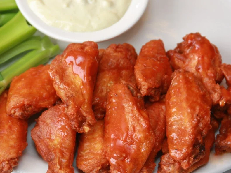 The favorite finger food of sports fans, Buffalo wings get their name from the city of their inception. There’s seemingly no such thing as a bad wing in Buffalo, but the establishment that rises above all others is the place where the wing was born. It started almost by accident as an experiment, on March 4, 1964. Anchor Bar co-founder Teressa Bellissimo’s son Dominic asked his mother to whip up a snack for his intoxicated friends late one night while he was tending bar. Teressa deep-fried the wings that were normally used as the base for stock, then flavored them with a secret sauce. While similar recipes have become mainstays on menus across the US, Teressa’s tightly guarded master recipe is only available at Anchor Bar.