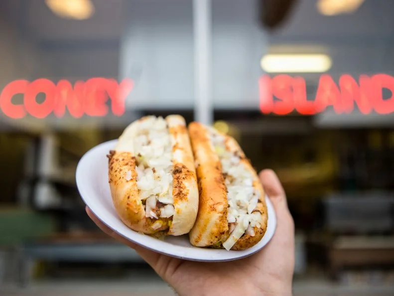 It’s not that Coney Dogs are an Indiana specialty, but Fort Wayne’s Famous Coney Island has become part of the city’s culinary heritage. The same family has operated it for a century, and the little restaurant doesn’t look much different than it did in the 1930s. Customers can still sit at the counter and watch the hot dogs being prepared. The go-to order is “three and a bottle” — three dogs with sauce, onions and mustard, with a bottle of Coke.