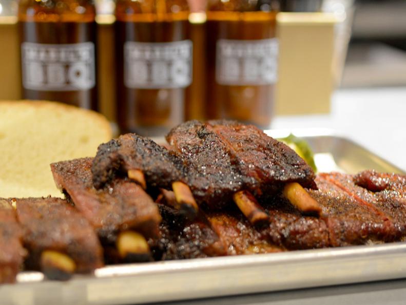 When Michael Symon set about opening a barbecue joint in the heart of downtown Cleveland, he said that he would be introducing diners to his brand of Cleveland-style barbecue. Sure, his slow-smoked beef brisket, pork ribs and pork belly are rooted in places like Texas, Memphis and the Carolinas. But the ingredients and techniques at Mabel’s BBQ have a characteristically Northeast Ohio flavor. Fueling Symon’s beefy smokers is a mix of indigenous fruitwoods like apple and cherry. In a nod to Cleveland’s great Jewish delis, Mabel’s rubs giant beef ribs with a blend of pastrami spices. Locally made kielbasa, from the nearby West Side Market, replaces the traditional Texas-style hot links, and the locally adored Bertman Original Ball Park Mustard makes an appearance in the Carolina-style sauce. Don’t come to Mabel’s and expect cornbread, mac and cheese or braised collards: Here, Eastern European-rooted sides like broccoli salad and spaetzle and cabbage prevail.