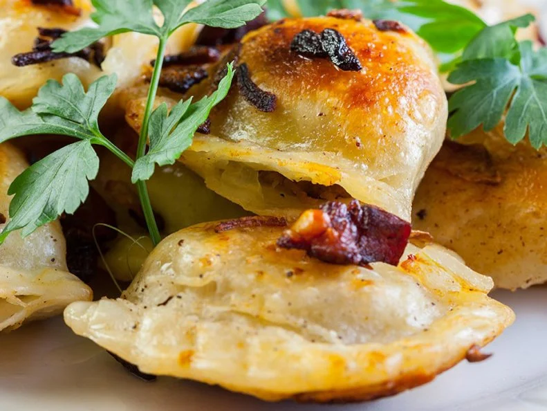 Parma, Ohio, is a working-class neighborhood of approximately 80,000 residents, nearly half of whom have roots that stretch back to Eastern European countries like Hungary, Poland, Slovakia and Slovenia â   places where the pierogi is king. Most Parma households still possess at least one family member who can fashion a few dozen pierogi in a jiff, but why bother when Perla Pierogies is on the job? The best pierogi, anybody will tell you, sport a gossamer-thin wrapper as opposed to those thick and gummy exteriors. Perla starts with fresh dough that is stretched to its delicate limit before adding a dozen different fillings like potato, potato and sauerkraut, and potato, cheddar and bacon. Each dumpling is pinched and pressed by hand and par-boiled, leaving just a minute in a hot pan (with butter and onions, naturally) at home to crisp them up.