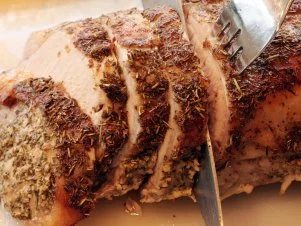 "Carving a tuscan pork roast.  Tuscan: rubbed with a mixture of garlic, salt, chrushed rosemary and olive oil before roasting.All images in this series..."