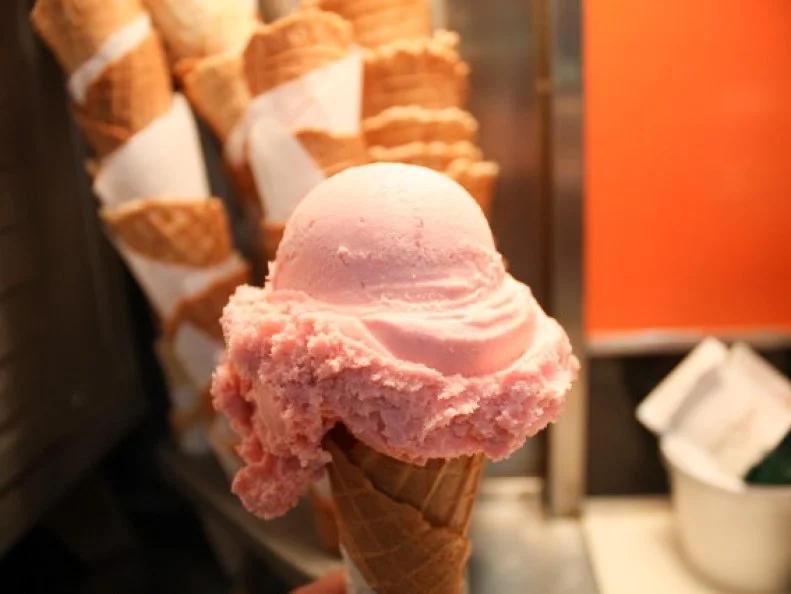 At the 1904 World's Fair in St. Louis, the ice cream cone made its debut thanks to an ingenious fellow named Albert "Abe" Doumar. Doumar, an immigrant from Damascus, Syria, noticed an ice cream stand shut down after it ran out of paper plates, while another vendor cranked out hot waffles served with a dollop of whipped cream. Curious, Doumar took that waffle, rolled it up and topped it with the ice cream. The marriage worked so well that Doumar, a traveling salesman, brokered a deal for the two vendors to create ice cream cones for the rest of the fair. Three years later Doumar opened his eponymous ice cream stand along the Atlantic Ocean in Norfolk, featuring freshly made cones from his specially engineered four-iron waffle maker.