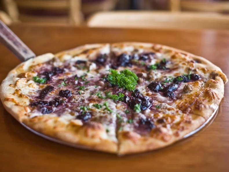 Biga Pizza in downtown Missoula uses fresh, local ingredients on innovative pies like the Flathead Cherry Pizza topped with housemade sausage, flathead cherry chutney, smoked gouda, mozzarella, garlic oil and parsley. Owner Bob Marshall buys cherries for his house-made chutney from The Orchard at Flathead Lake, which has been in the Johnson family since 1976. Marshall also runs daily and weekly specials showcasing whatever happens to be fresh and available — be it wild mushrooms, beef short ribs, dried chiles, shallots, apples or something totally different.
