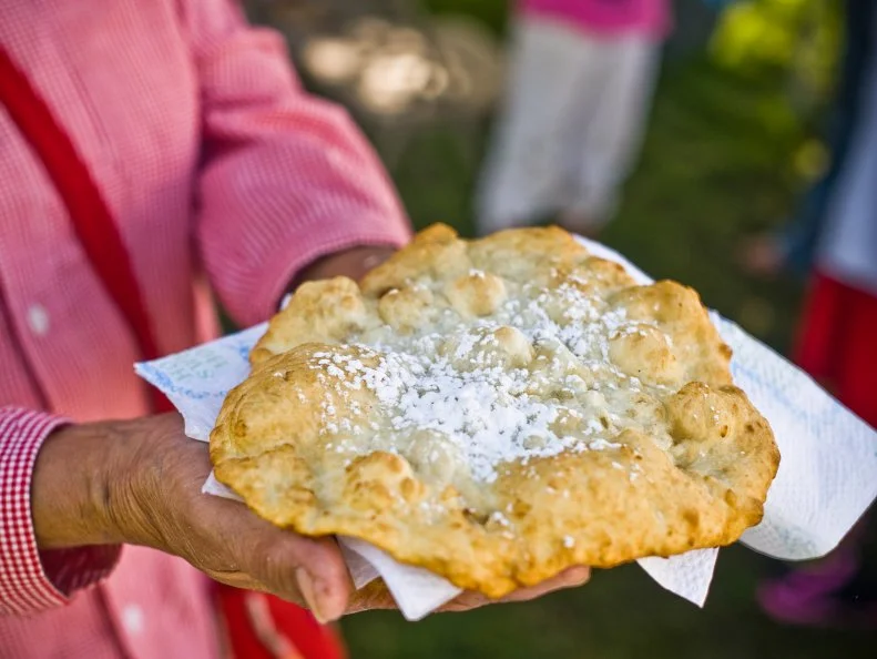 If you’re not lucky enough to have a grandmother or special auntie who makes fry bread, then head to Crow Fair the third weekend in August. Held on Montana’s Crow Reservation, the annual event celebrates Native American culture, and reunites family groups with a traditional powwow, dances and Indian horse races. At the center of “Teepee Capital of the World” is a dance arbor surrounded by vendors selling all sorts of carnival fare — including fry bread and Indian tacos (fry bread with taco toppings). Locals eat theirs unembellished, slathered in honey, or sprinkled with cinnamon and sugar.