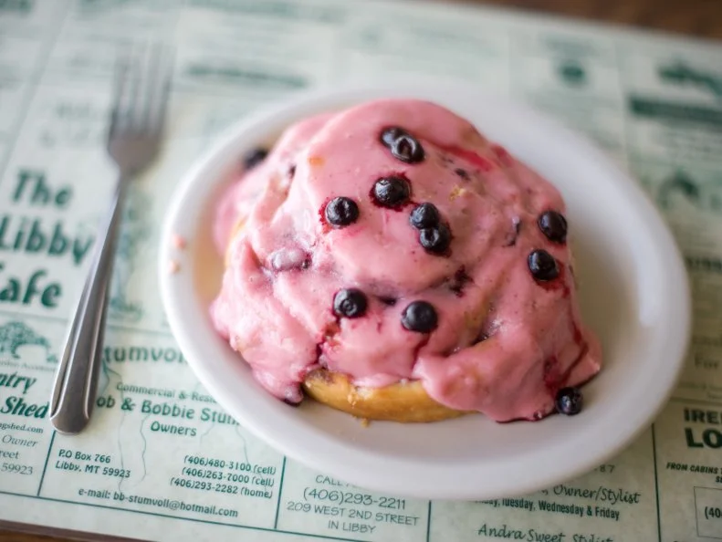 “The whole reason we moved to Montana 23 years ago was because of my husband’s mistress: the Montana huckleberry,” jokes Paulette Njirich, who owns the Libby Cafe with spouse Jim. Each year, the Njiriches purchases more than 1,700 pounds of plump, purple berries from local pickers to feature in items like Huckleberry Flapjacks drenched in homemade huckleberry syrup. “They’re not a pancake; they’re not a crepe,” explains Jim (who inadvertently invented them one day by adding huckleberries to potato flapjack batter), when describing the flapjacks’ texture. “And they’re loaded with huckleberries,” adds Paulette, who crafts from-scratch Huckleberry Swirls. “I dust [the dough] with finely ground walnuts, sugar and lemon and really pile on the berries. Then I roll them up and bake before topping them with huckleberry cream frosting.”