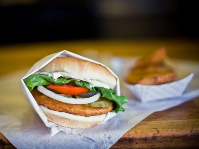 In 1923, John Burklund began selling bone-in pork chop sandwiches to miners and passersby out of a horse-drawn wagon in Uptown Butte. By the time John Orizotti bought the business in 1969, the sandwiches were a staple of local cuisine. Today, Orizotti’s son Ed serves the crispy and succulent Montana icons (no longer available bone-in) at two Butte locations. Sit at the Uptown shop’s 10-seat counter and order John’s Original: a boneless pork sirloin breaded with housemade batter, deep fried and garnished on a locally-made four-and-a-half inch bun. Locals top theirs with cheese, ham or egg. Some even add a burger on top!