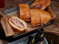 A Muffuletta is a pressed sandwich -- filled with cold cuts, cheese and an olive spread -- that only gets better as it sits. So it's the perfect thing to take on a camping trip: while you're out hiking or fishing, its flavors will meld all the more.