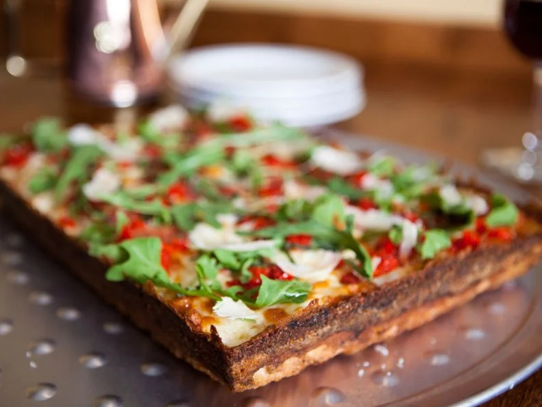 For Jeff “Smoke” Smokevitch, finding a way to bring his hometown favorite pizza to the West was a must, but with the altitude change in the Colorado mountains, it wasn’t an easy feat. After much trial and error — and a stint at the International School of Pizza — Smokevitch figured out how to make true Detroit-style pizza in Telluride. The square pizza is baked in the standard blue steel automotive pans to help create that crisp and caramelized crust. Smokevitch puts his own spin on the classic Detroit cheese combo, though, adding aged white cheddar to the expected mix of brick and mozzarella. As for the finishing touch? He keeps it totally traditional with a drizzle of red sauce atop all that wondrously molten cheese. 