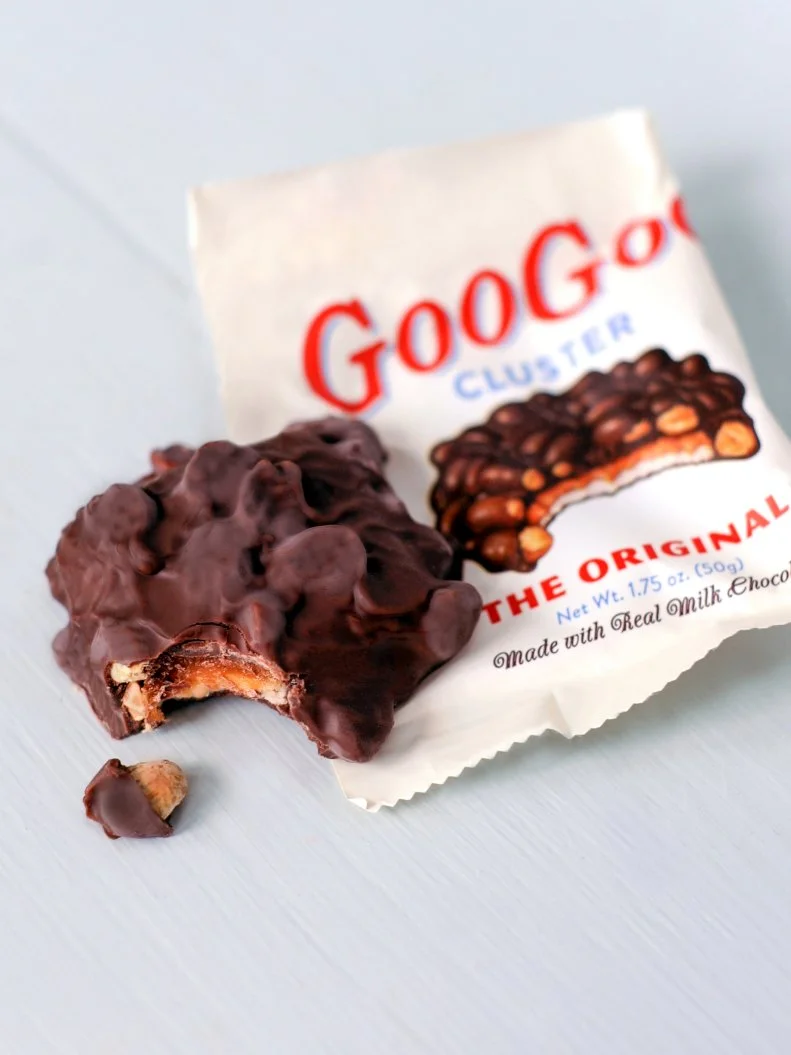 The Goo Goo Cluster is a confection that was invented by the Standard Candy Co. more than a century ago when they combined marshmallow nougat, caramel and roasted peanuts into a disc-shaped bar covered in milk chocolate. Associated with Nashville and the Grand Ole Opry, the Goo Goo has spread in popularity around the country, especially thanks to its availability in airport gift shops. The company has recently opened a retail location in downtown Nashville, where visitors can buy the original and premium versions of their products.