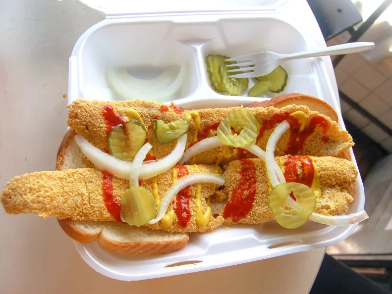 A water-born cousin to Nashville’s iconic hot chicken sandwich, hot fish sandwiches usually feature oversized fillets of whitefish or catfish overshooting the edges of the white bread slices that attempt to contain them. Torqued up with splashes of hot sauce and neon yellow mustard and accompanied by pickles and raw white onion, the best hot fish sandwiches are golden and crispy on the outside with a tender interior. They are usually encountered off the beaten track in places like  Ed’s Fish & Pizza House, which stopped making pizzas years ago because the sandwiches were too darned good to justify a pie.