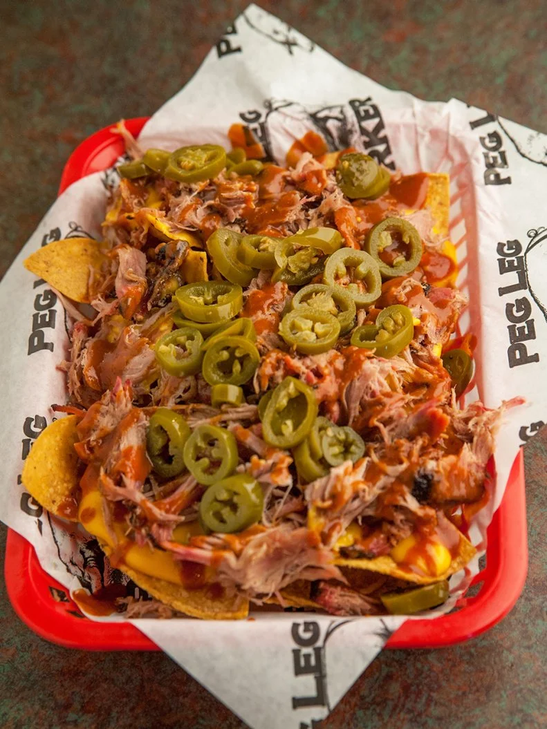 This seemingly odd combo of pulled pork and a Tex-Mex specialty surprises a lot of people when they spot it on a menu. It turns out that a tortilla chip is a very effective delivery device to bring delicious barbecue from plate to mouth. At the Peg Leg Porker barbecue restaurant in Nashville, a heaping helping of pork arrives topped with tangy barbecue sauce, creamy cheese sauce and jalapeño slices for a dish that’s big enough to share.