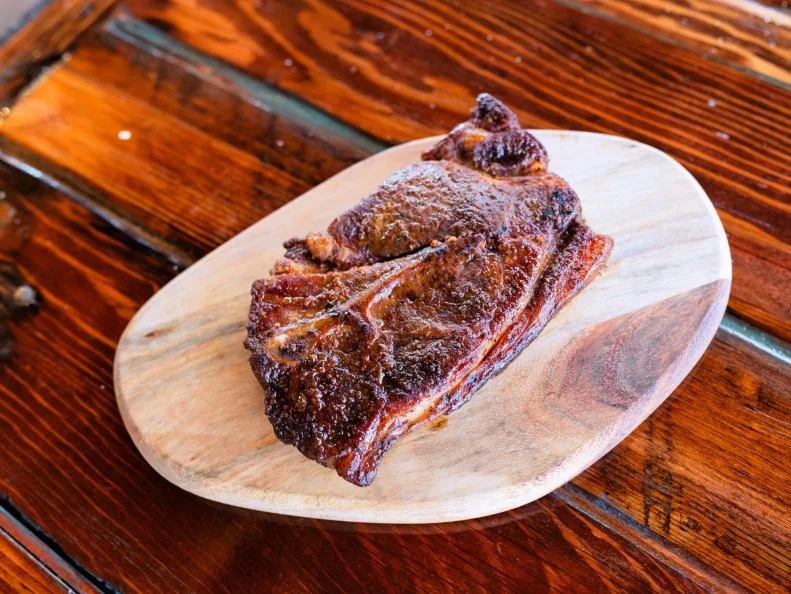 Pork steaks have been a St. Louis staple since the 1950’s, when a local grocery chain began selling pork shoulder, thinly sliced, to rival beef steaks. What once was commonly an overcooked, over-sauced barbecue item has reemerged as something much tastier, especially at Bolyard’s Meat & Provisions. Their inch-thick steaks are brined overnight, rubbed with blend of paprika, garlic, brown sugar and assorted other spices, then smoked over cherry wood for five hours. Bring them to your friend’s next barbecue and claim you made them.
