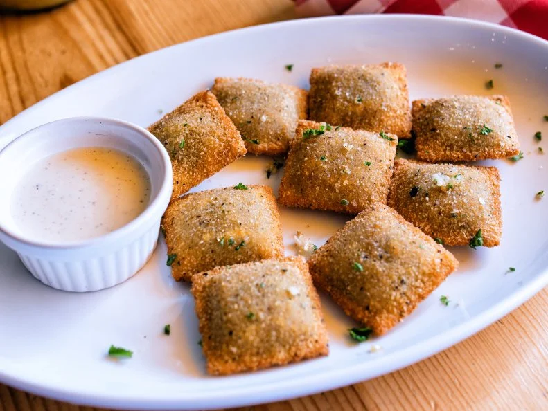 Toasted ravioli — which are, in fact, fried — are exactly what they sound like: crispy, breaded ravioli. They’re typically filled with seasoned ground meat and served with marinara sauce, but not so at upscale barbcue joint Salt + Smoke. No, sir! They fill their ravioli with chopped oak-smoked burnt ends, topped with a sprinkle of garlic and herbs and served with an Alabama-style white barbecue dipping sauce. Resistance is futile.