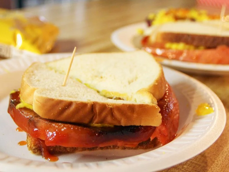 Sweet and tangy barbecue sauce and an extraordinarily pungent sweet and sour yellow coleslaw differentiate the cheap, comforting sandwiches and plates you’ll get at this old cinderblock stop along Lamar Avenue. Smoked sausages and chopped and pulled pork star on the simple menu, though the best secret may be the sloppy smoked-barbecue sandwiches, served on white bread with a smile and a cheery greeting at the counter.