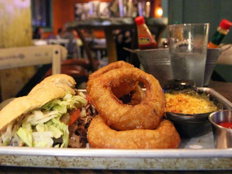 Chef Kelley English’s hip take on Cajun and Creole comfort food sits next to his esteemed Restaurant Iris. Here, true New Orleans-style po’boys and working-man sides should be familiar to those who have spent time in Crescent City. Get a fork with The Verno, a po’ boy stuffed with braised chicken thighs and Swiss cheese. The spinach Madeleine is worth the visit all on its own. As with most New Orleans spots, the cocktails and craft beers are ideal accompaniments.
