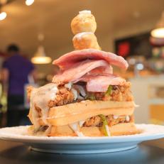 Beauty shot of featured dish Chicken Fried Steak & Waffles at Maple Leaf Diner in Dallas as seen on Food Network's Incredible Edible America
