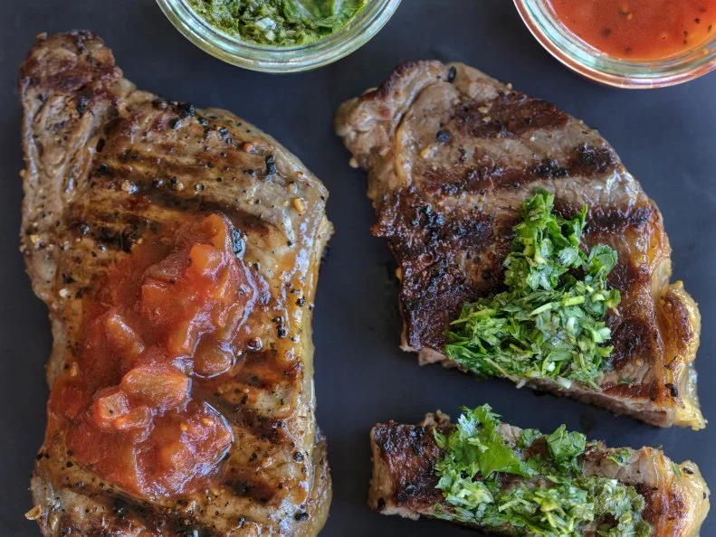 Rachel Ray's recipe for strip steaks with two sauces, one red and one green. Food photography by Jackie Alpers for FoodNetwork.com