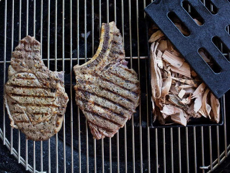 smoking steaks on the grill with wood chip smoker. Food photography by Jackie Alpers for FoodNetwork.com