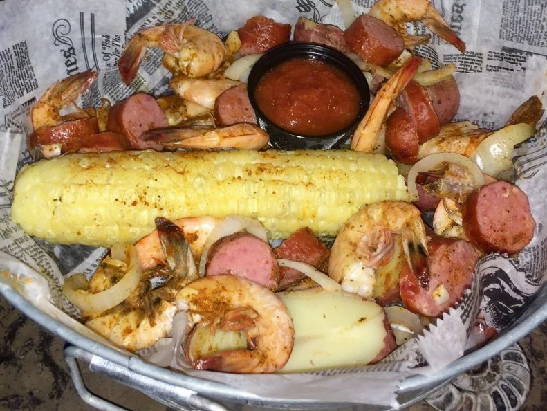 Frogmore Stew isnâ  t really a stew at all: Itâ  s a one-pot meal featuring the Lowcountryâ  s peak summer delicacies. It combines seafood, potato, sausage and corn on the cob, in a boil thatâ  s typically spread out over a newspaper-laden picnic table for communal dining. The recipe apparently originated in the community of Frogmore on St. Helena Island. So, itâ  s fitting to head to Foolish Frog at the crossroads in Frogmore to enjoy their Frogmore Pot. With local shrimp right out of the ocean off nearby Hunting Island, as well as sweet onion, potato, beef sausage, fresh corn on the cob from Dempsey Farms down the street, and a blend of seasonings, itâ  s a Southern specialty served at its source.