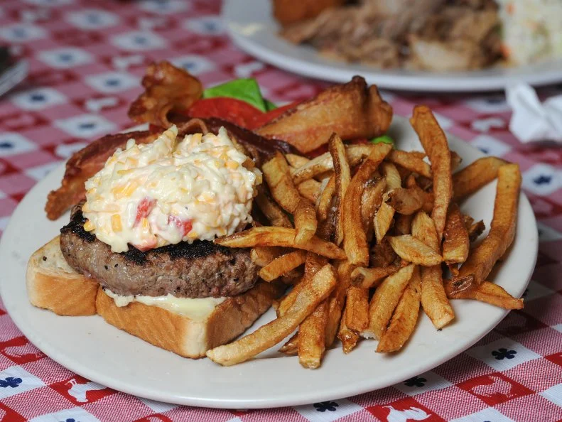 A childhood classic, beloved picnic food and staple for Southern chefs, pimento cheese has become one of the ‘it’ ingredients on menus across the state. Some argue it has lost its way with too many ingredients and too much refinement, but Heidi and Joe Trull at Grits & Groceries in Belton have kept it simple. Their recipe relies on the sharp tang of cheddar, the creaminess of Monterey Jack, the slight spice of roasted red peppers, creamy Duke’s mayo and a touch of grated onion.. Oh yeah, and it’s served on their own grass-fed beef burger with bacon, on buttered Texas toast.