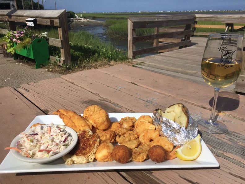 South Carolinians love a good old-fashioned fish fry, with all sorts of seafood fried to a perfect golden brown and served piping hot with sides and lots of napkins. Located in the oldest building along the Grand Strand, Hot Fish Club in Murrells Inlet — known as the seafood capital of South Carolina — is a true local joint ,paying homage to the original 1700s-era Hot and Hot Fish Club social club located on nearby Drunken Jack Island. Nothing screams iconic South Carolina food more than the Hot Fish Platter, loaded with fresh, golden-fried local flounder, shrimp, oysters and crab cakes, sourced from the inlet just steps away, with creamy slaw, a hot baked potato and hushpuppies.