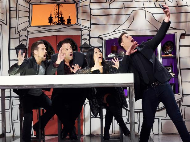 Host Jonathan Bennett, guest judge Shane West and judges Shinmin Li and Todd Tucker take a selfie together, as seen on Food Network’s Halloween Wars, Season 7.