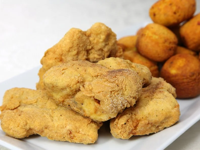 Catfish is as synonymous with Mississippi as cotton. Much of what’s served today, in fact, is produced in raised ponds where cotton once grew. Mild, clean-tasting farm-raised catfish has been vital to Mississippi’s economy since the 1960s, when locals pioneered the industry. But catfish fries have always been fun family entertainment for Mississippians, even when all they had to work with were the bottom-feeding river dwellers caught on a cane pole. Old-time catfish houses are scattered throughout the Mississippi landscape, serving heaping platters of whole fish and fillets — fried the traditional way in cornmeal jackets and sometimes grilled with Cajun seasonings. All come with the traditional trappings: crispy balls of onion-flecked cornbread batter called hush puppies, as well as French fries, coleslaw and tiny paper cups of tartar sauce and ketchup. One of the most-popular places to experience an old-school Mississippi catfish fry is Taylor Grocery, a ramshackle building at the end of a dirt road in the north Mississippi village of Taylor, near Oxford. People come from miles around for expertly prepared examples of the classic feast, often set to local live music and always served with heaps of authentic down-home atmosphere.