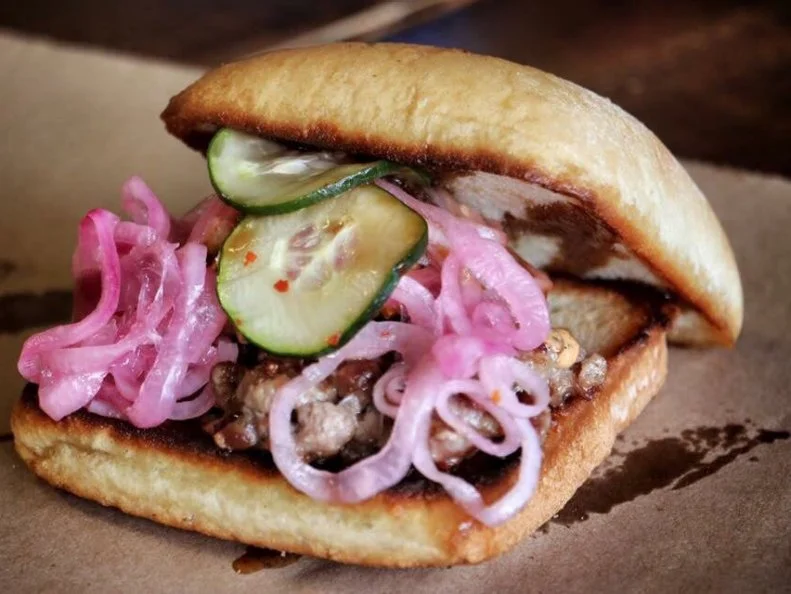 The Neon Pig is a farm-to-table café, pub and grocery started in Tupelo by Mitch McCamey and Seth Coleman, a couple of young, well-traveled chefs who returned to their cattle-farming roots. Whole-animal butchery is their specialty, and so is one of its byproducts: the Smash Burger. They make the “smash” by grinding scraps from their aged steaks and artisanal bacon, which they flavor with hoisin and comeback sauce and pile into a ciabatta bun with melted cheddar, pickled onions, pickles and more bacon. Their creation went over so well with customers that in 2015, the duo entered their signature burger in a contest for top burger in the country — and won. The Smash Burger continues to win fans at both the original and new Oxford Neon Pig location, and they also sell the custom-ground meat in the grocery for those who prefer to do their own flipping.