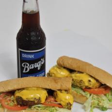 Of all the New Orleans creations to migrate across the Mississippi border, the po’ boy may be the most-prevalent, especially along the Gulf Coast. In the 1940s, a Biloxi restaurateur put his spin on this sandwich by toasting and pressing the bread on a grill after assembling the sandwich. When a customer from Vancleave asked for one with a fried crab patty and melted cheese, the combo now known by locals as the Vancleave Special was born. Though not necessarily mentioned by name, versions and adaptations can be found throughout the region, including at the The Po-Boy Express in Ocean Springs (theirs are toasted but not pressed). For a full Gulf Coast experience, wash it down with an ice-cold Barq’s Root Beer, the hometown soft drink of Biloxi, bottled there for a century.