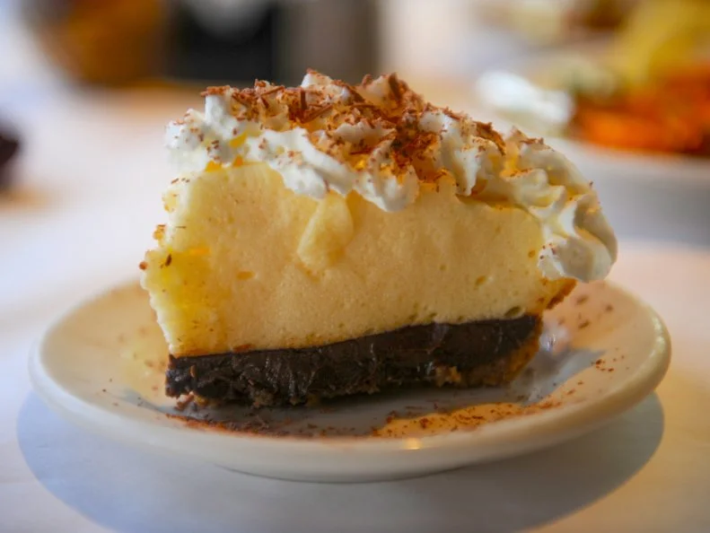 Though often considered a classic Southern dessert, black bottom pie has also been attributed to a chef in California in the 1940s. Whatever its origins, Mississippians have long associated it with Weidmann’s, a Continental-style restaurant with a heavy Creole accent in downtown Meridian. Their recipe, which has appeared in countless community cookbooks, features a gingersnap crust topped with two custards — one chocolate and the other spiked with bourbon — crowned with whipped cream and chocolate shavings. The restaurant’s menu and décor have evolved over the years but the signature pie remains constant.