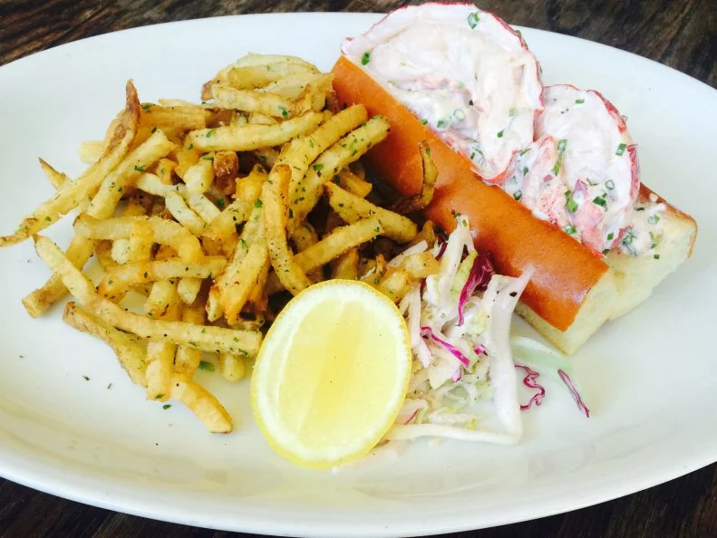 This Southern restaurant gives Maine some major love on Fridays and Saturdays with a lobster roll lunch special that lures in the locals. These sandwiches feature 1 1/4-pound lobsters that arrive live from New England to ensure maximum freshness. Executive Chef Brian Horn imparts a touch of extra flavor by poaching the succulent crustaceans in court bouillon, then chills the lobster meat until the orders roll in. He ups the flavor ante by adding mayo, fresh herbs, salt, pepper, lemon juice and zest to the chilled meat before heaping it onto a buttered, toasted roll from a local bakery. Each sandwich comes flanked by a side of fries, apple slaw and a lemon slice. These lobster rolls go fast, so best get there early if you want to hook one for lunch.