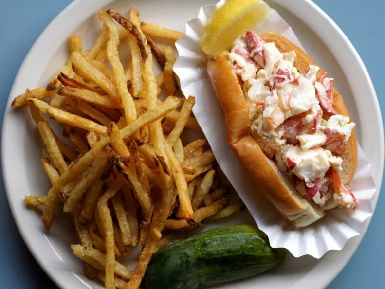 The culinary minds behind this retro restaurant concept rounded up a collection of America’s most-beloved regional specialties for their menu, including a lobster roll made in Maine’s signature style. Steuben’s sandwich bursts with bright flavor, thanks to a rigorous delivery schedule. “Our lobster is flown in live daily and prepped fresh in our kitchen,” says COO Emily Biederman. Once cooked, the tender morsels of lobster meat are lightly dressed with mayo, paprika, celery, lemon juice, salt and black pepper, then nestled in a griddled split-top roll. This Maine staple comes served with another American classic: housemade fries and a pickle.