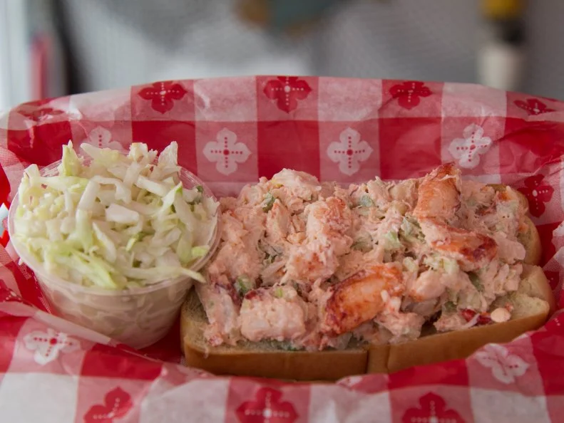 For more than 50 years, diners have flocked to this cheerful spot in the Hamptons that offers a seafood-centric menu and a beachy, throwback vibe… right down to the retro sign that earned this spot its nickname of Lunch among locals. Opt for the Classic Lobster Roll on the menu and you’ll get a toasted-on-the-outside bun spilling over with mounds of chilled claw and knuckle meat that co-owner Andrea Anthony describes as “very tender and sweet.” She tosses the succulent morsels of cold-water lobster with mayo and a bit of chopped celery for added texture, then piles them into the split-top roll that’s toasty on the outside and soft on the inside. “We’re all about quality and simplicity,” says Anthony, who also offers a gluten-free version of this menu mainstay. 
