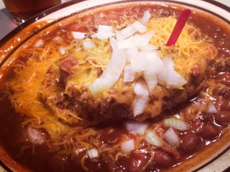The Barrel Bar in Hastings, Nebraska, deserves a special shout out for its uber-creative way to fit as much ground beef onto a plate as possible. Their creation is called the Stromer, and it's been a mainstay at the Barrel as long as anyone can remember. The stromer is a cheese charburger covered in meaty chili, served open-faced with sliced onion on a single bun. Itâ  s like a chili-cheese dog, except with more hamburger and better. You can actually get a Polish stromer, their version of a chili cheese dog with Polish sausage, at the Barrel Bar, too.