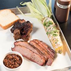 The Notorious P.I.G. BBQ’s signature plate Burnt Beef Ends and Beef Brisket with Smoked Corn Elote with Alabama White Sauce and Smoked Beans, as seen on Food Network’s I Hart Food, Season 1.