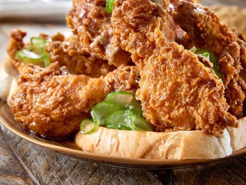 This Southern-tinged restaurant, which is nestled in The Confidante hotel, serves hot chicken in sandwich form at lunch, and in various forms over waffles at breakfast and dinner. Chef Richard Hales brines the birds for 24 hours, then dredges them in flour and buttermilk to fry. Cayenne dominates the spice blend, with salt, dry mustard, smoked paprika and garlic powder in warm oil to adhere the blend. To assemble the popular sandwich, Hales stacks hot tenders and housemade pickles on cult-favorite Zak the Baker brioche slathered with local honey and house mustard. Halesâ   first taste of fried chicken inspired him to add it to the menu. â  All my restaurants use plenty of chile, so it was a natural progression,â   he says. Hales recommends following the hot sandwich with â  ice cream and lots of it!â  